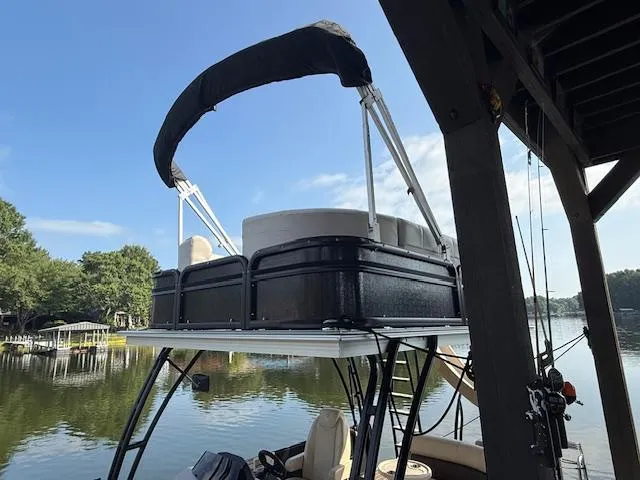 Slide: The Image of 2022 Premier 250 Sunsation pontoon boat docked on a serene lake. - 4