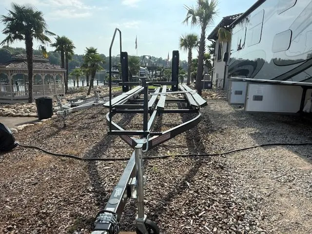 Slide: The Image of Trailer for 2022 Premier 250 Sunsation boat, parked near palm trees and a waterfront. - 41