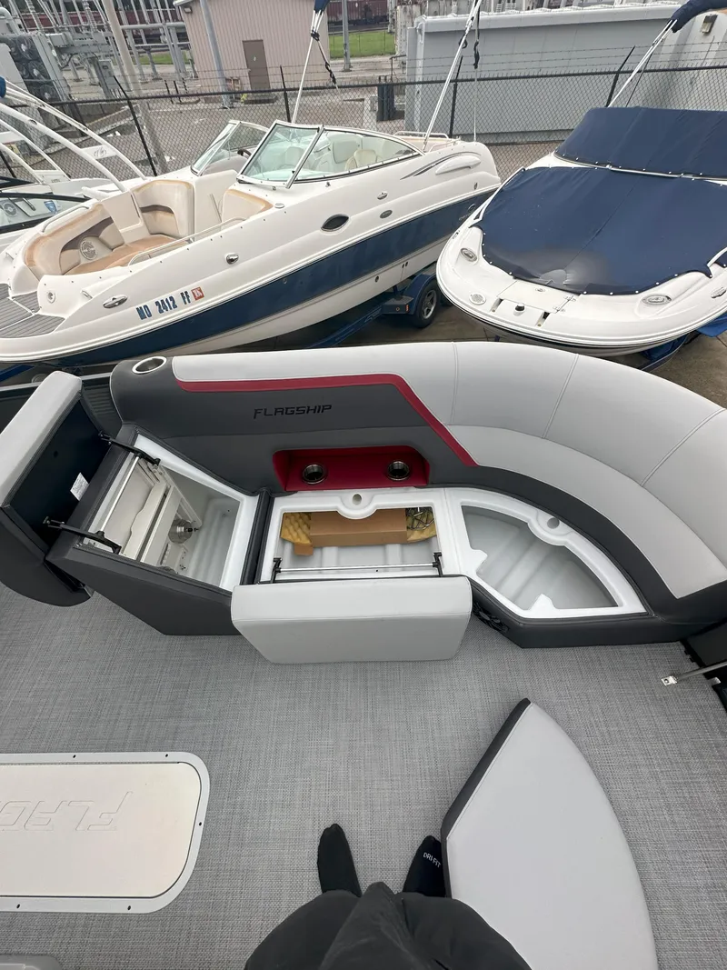 Slide: The Image of 2026 Flagship D22CU Extended Deck boat with open storage compartments and seating. - 10