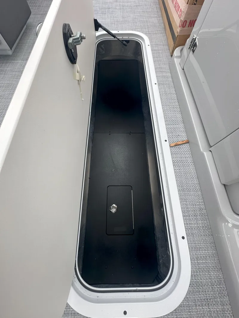 Slide: The Image of Open storage compartment on 2026 Flagship D22CU Extended Deck boat. - 12