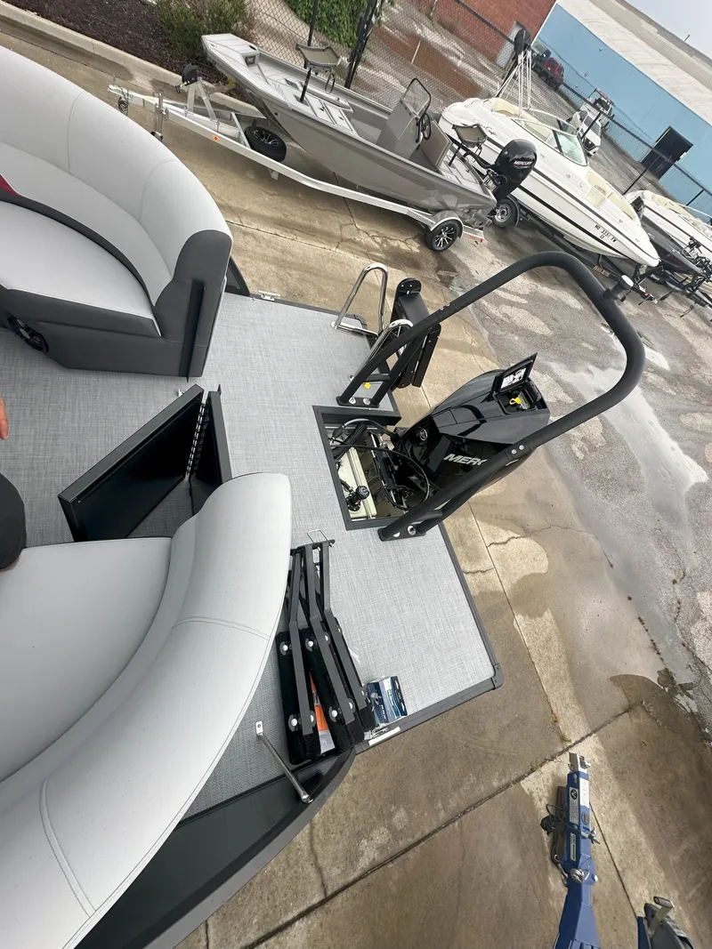 Slide: The Image of 2026 Flagship D22CU Extended Deck boat with seating and motor, docked near other boats. - 15