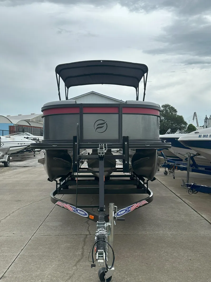 Slide: The Image of 2026 Flagship D22CU Extended Deck pontoon boat on trailer, parked outdoors. - 2