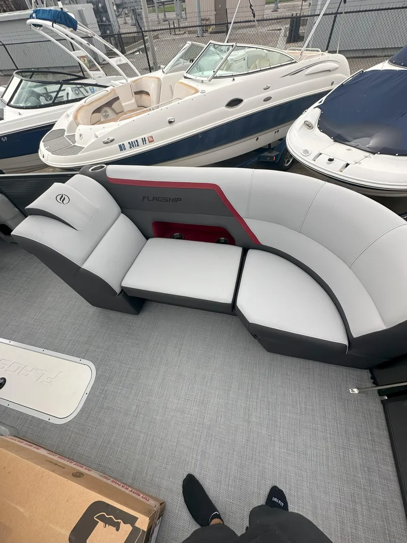 Slide: The Image of 2026 Flagship D22CU Extended Deck with modern seating, docked among other boats. - 9