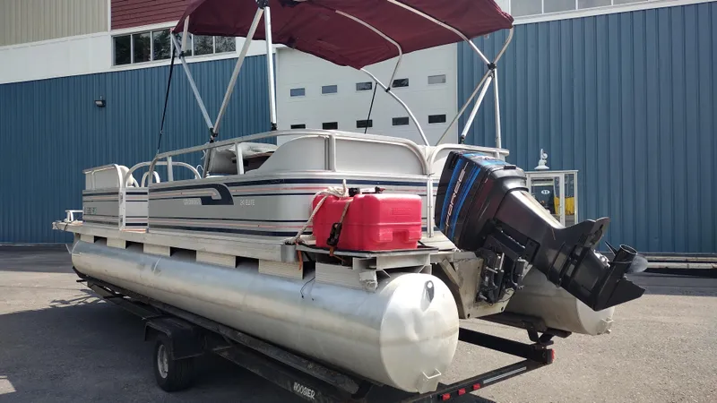 Slide: The Image of 1991 Grumman Funship 24' pontoon boat with outboard motor and red canopy. - 7