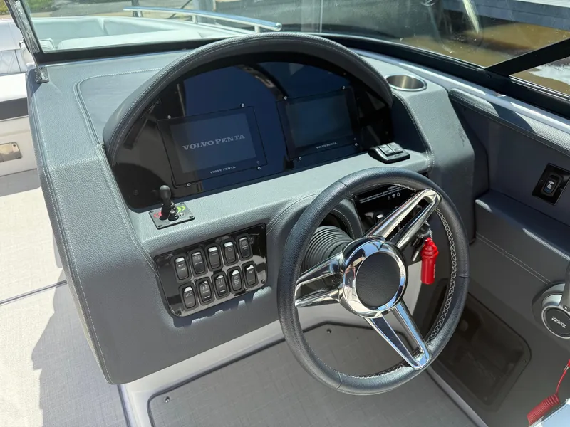 Slide: The Image of 2023 Regal 2800 Bowrider dashboard with steering wheel and Volvo Penta display. - 10