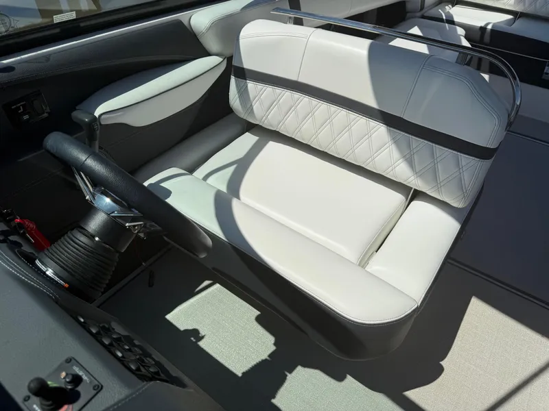 Slide: The Image of 2023 Regal 2800 Bowrider cockpit with luxurious white seating and steering wheel. - 11