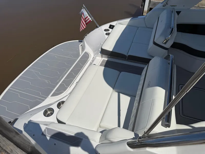 Slide: The Image of 2023 Regal 2800 Bowrider boat interior with white seating and American flag. - 13