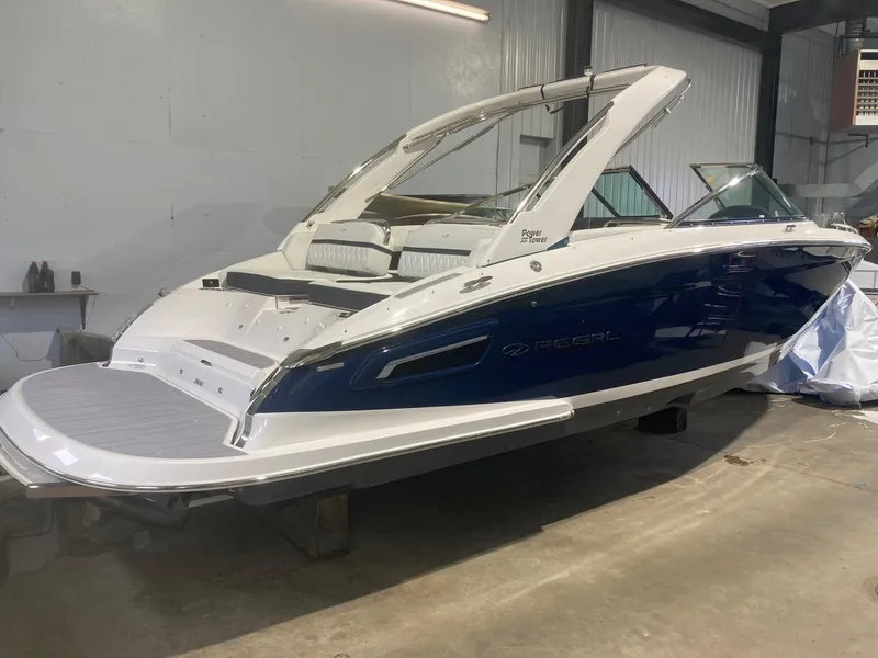 Slide: The Image of 2023 Regal 2800 Bowrider boat in a garage, showcasing sleek design and modern features. - 2