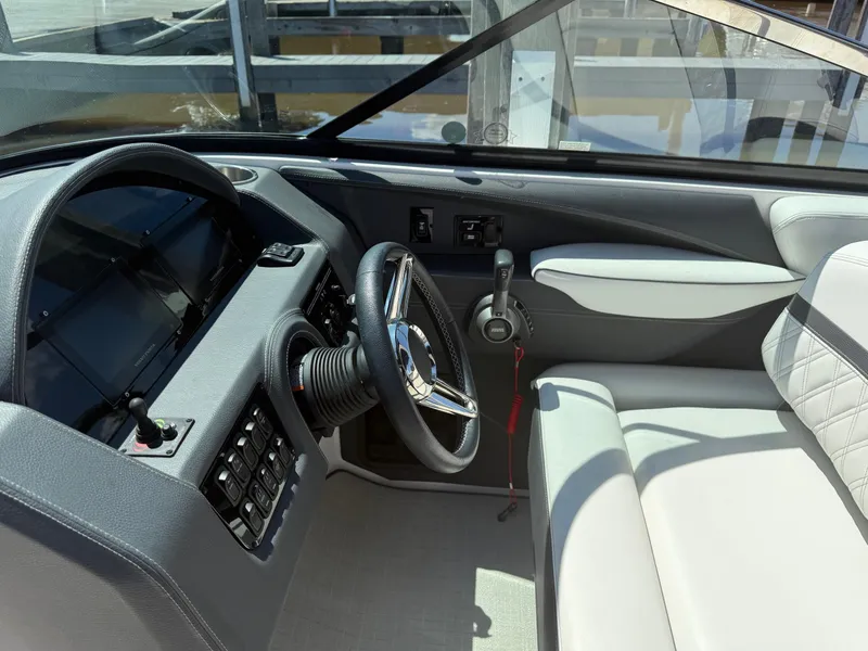 Slide: The Image of 2023 Regal 2800 Bowrider cockpit with steering wheel and control panel. - 30