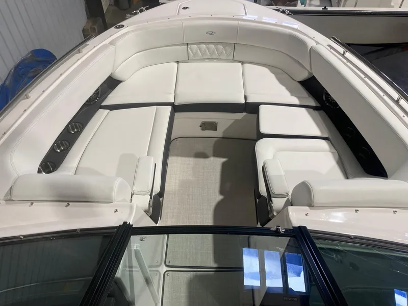 Slide: The Image of 2023 Regal 2800 Bowrider interior with white seating and cup holders. - 6