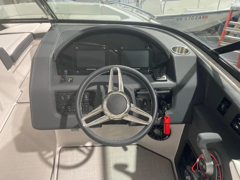 Slide: The Image of 2023 Regal 2800 Bowrider dashboard with steering wheel and control panel. - 8