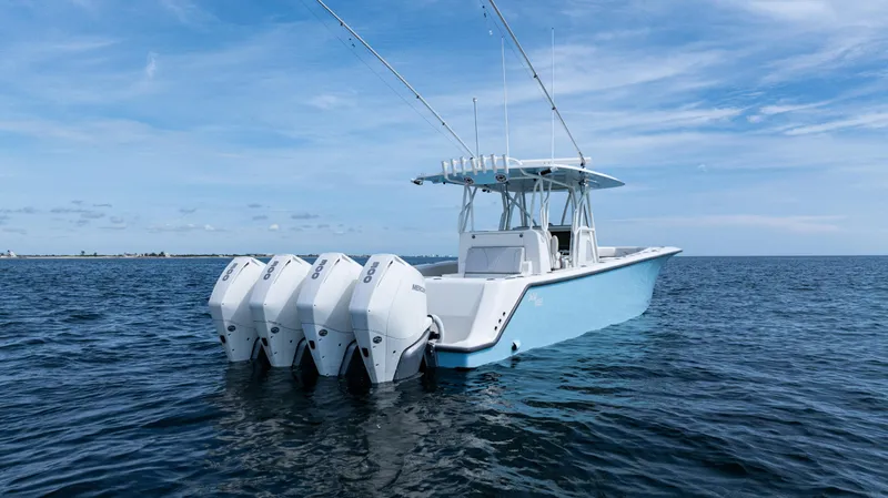 Slide: The Image of 2021 SeaVee 390 boat with four outboard engines on open water. - 1