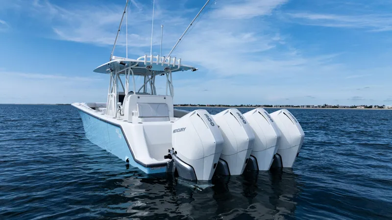 Slide: The Image of 2021 SeaVee 390 boat with four Mercury outboard engines on open water. - 10