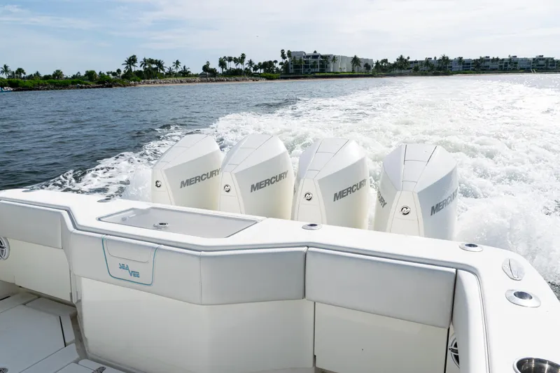 Slide: The Image of 2021 SeaVee 390 boat with four Mercury engines cruising on open water. - 11