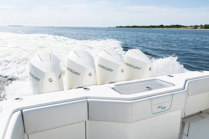 Slide: The Image of 2021 SeaVee 390 boat with four Mercury engines cruising on open water. - 12