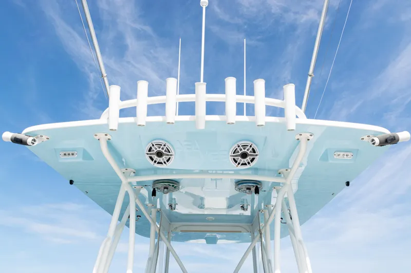 Slide: The Image of SeaVee 390 boat tower, 2021 model, with rod holders and speakers against blue sky. - 13