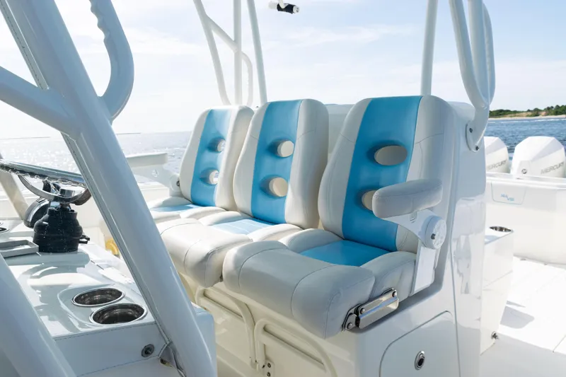 Slide: The Image of 2021 SeaVee 390 boat interior with blue and white cushioned seats. - 14