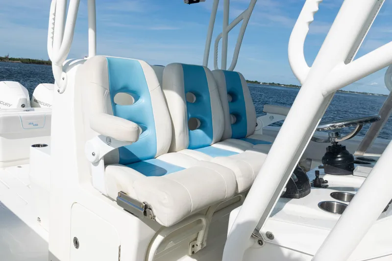 Slide: The Image of 2021 SeaVee 390 boat interior with blue and white seating, ocean view in background. - 15