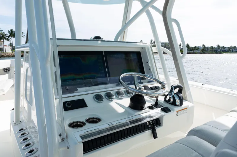 Slide: The Image of 2021 SeaVee 390 boat dashboard with steering wheel and navigation screens. - 17