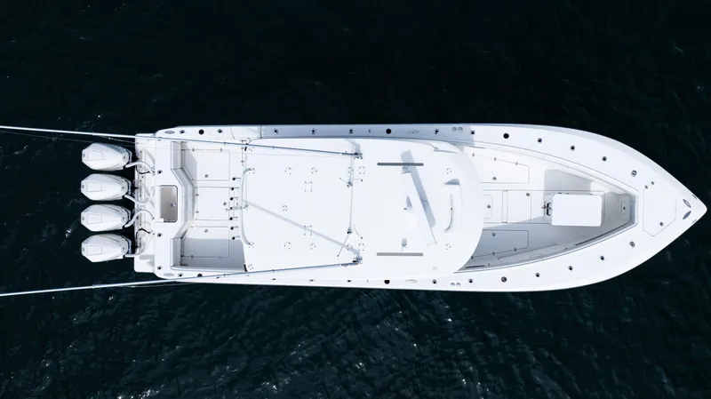 Slide: The Image of Aerial view of 2021 SeaVee 390 boat with triple outboard engines on water. - 19