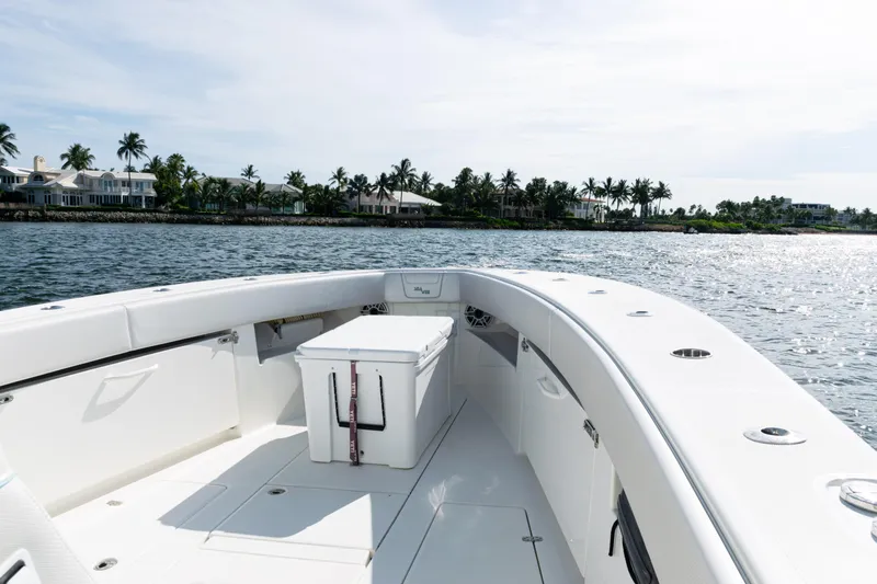 Slide: The Image of 2021 SeaVee 390 boat on water, with coastal homes and palm trees in the background. - 23