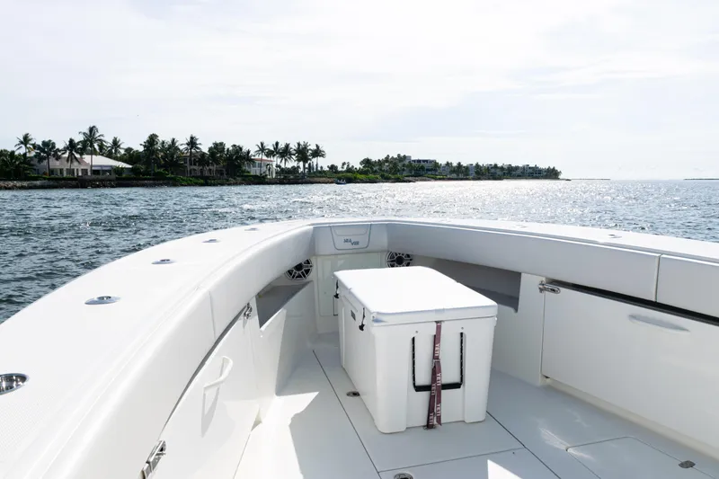 Slide: The Image of 2021 SeaVee 390 boat on water, featuring spacious deck and scenic coastal view. - 24