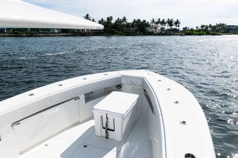 Slide: The Image of 2021 SeaVee 390 boat on water, featuring spacious deck and cooler. - 27