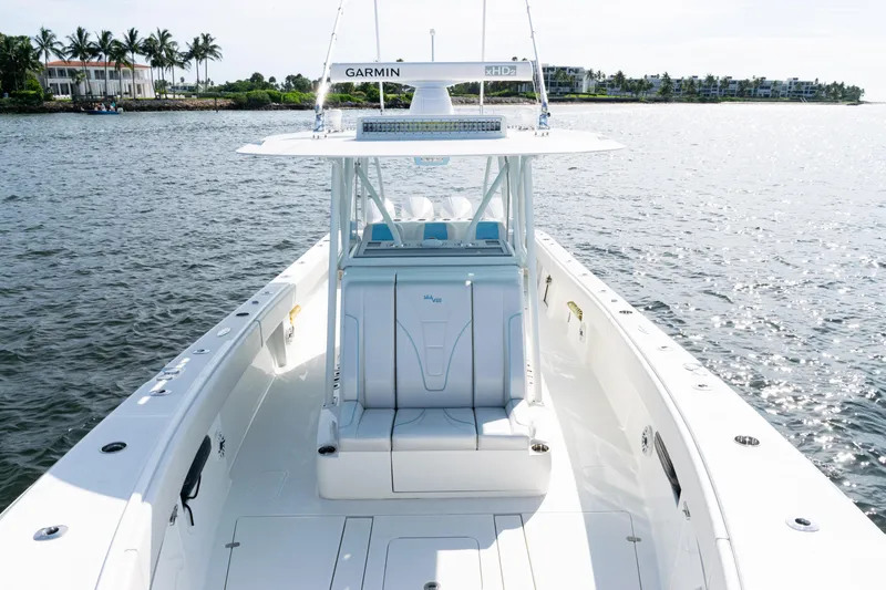 Slide: The Image of 2021 SeaVee 390 boat on water, featuring Garmin equipment, with coastal background. - 35
