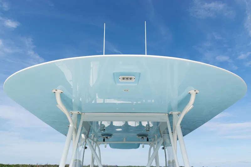 Slide: The Image of 2021 SeaVee 390 boat's sleek blue canopy against a clear sky. - 39