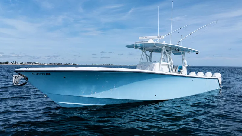 Slide: The Image of 2021 SeaVee 390 boat on calm ocean waters under a clear blue sky. - 4