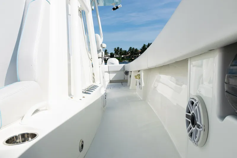 Slide: The Image of 2021 SeaVee 390 boat deck with white seating and speakers, under clear blue sky. - 43