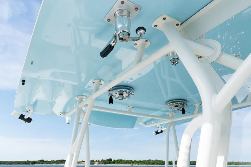 Slide: The Image of 2021 SeaVee 390 boat's T-top with mounted equipment against a clear sky. - 46
