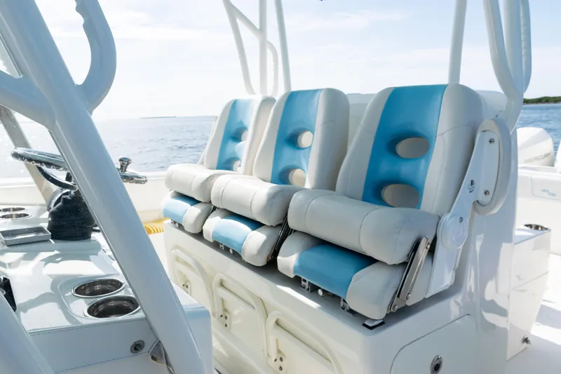 Slide: The Image of 2021 SeaVee 390 boat interior with blue and white seating, ocean view. - 48