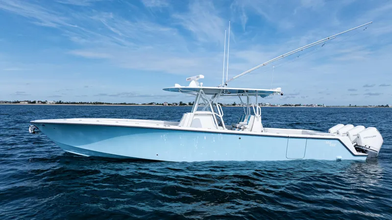 Slide: The Image of 2021 SeaVee 390 boat on calm ocean waters under a clear blue sky. - 5