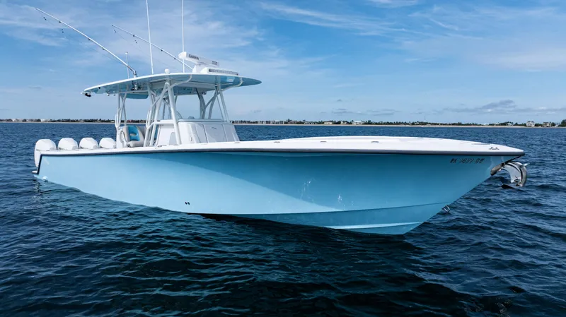 Slide: The Image of 2021 SeaVee 390 boat on calm ocean waters under a clear blue sky. - 7