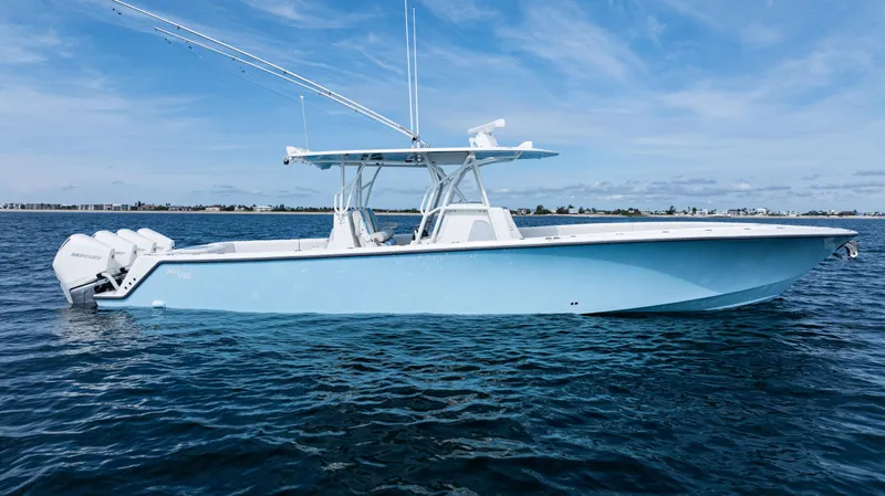 Slide: The Image of 2021 SeaVee 390 boat on calm water, featuring a sleek design and multiple outboard engines. - 8