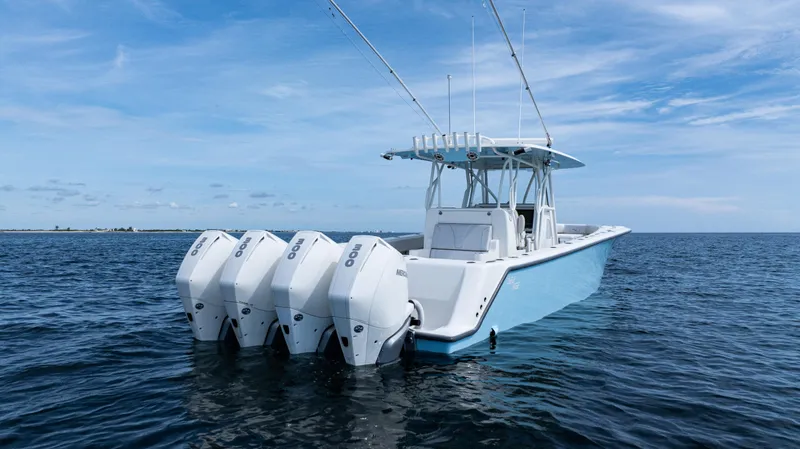 Slide: The Image of 2021 SeaVee 390 boat with four engines on open water under blue sky. - 9