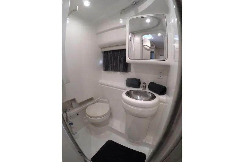 Slide: The Image of Compact bathroom in 2003 Formula 31 Performance Cruiser with sink, toilet, and mirror. - 16