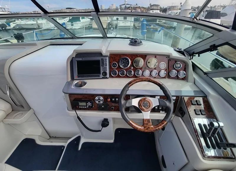 Slide: The Image of 2003 Formula 31PC boat cockpit with steering wheel, gauges, and navigation equipment. - 6