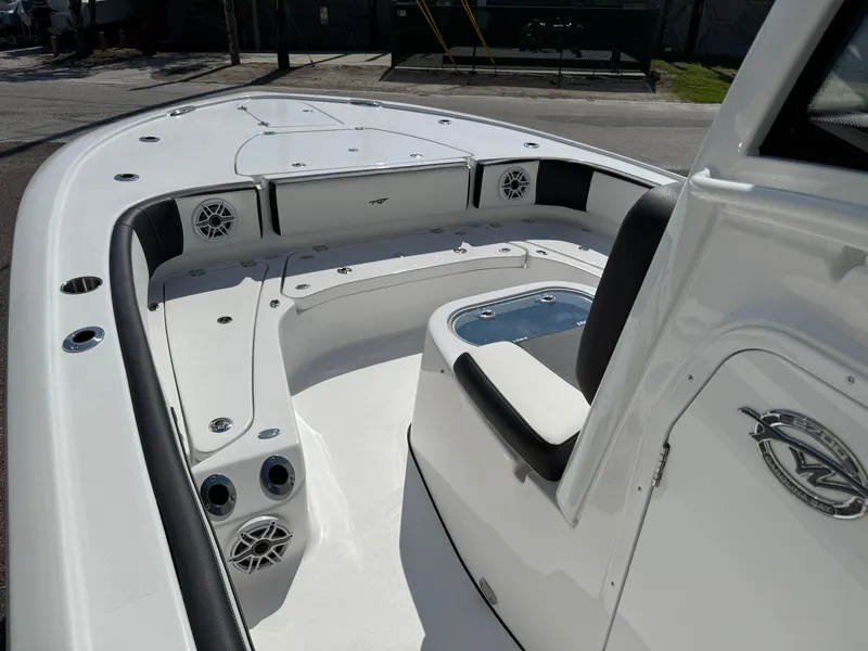 Slide: The Image of 2026 Tidewater 2700 Carolina Bay boat interior with seating and speakers. - 16