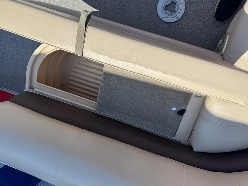 Slide: The Image of 2017 Sun Tracker Party Barge 20 DLX storage compartment with beige seating and carpeted flooring. - 11