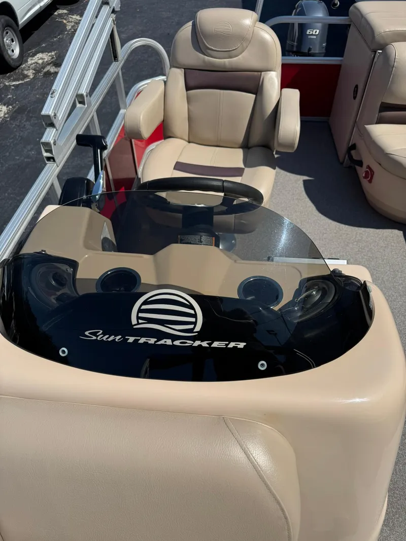 Slide: The Image of 2017 Sun Tracker Party Barge 20 DLX helm with beige seating and steering console. - 6