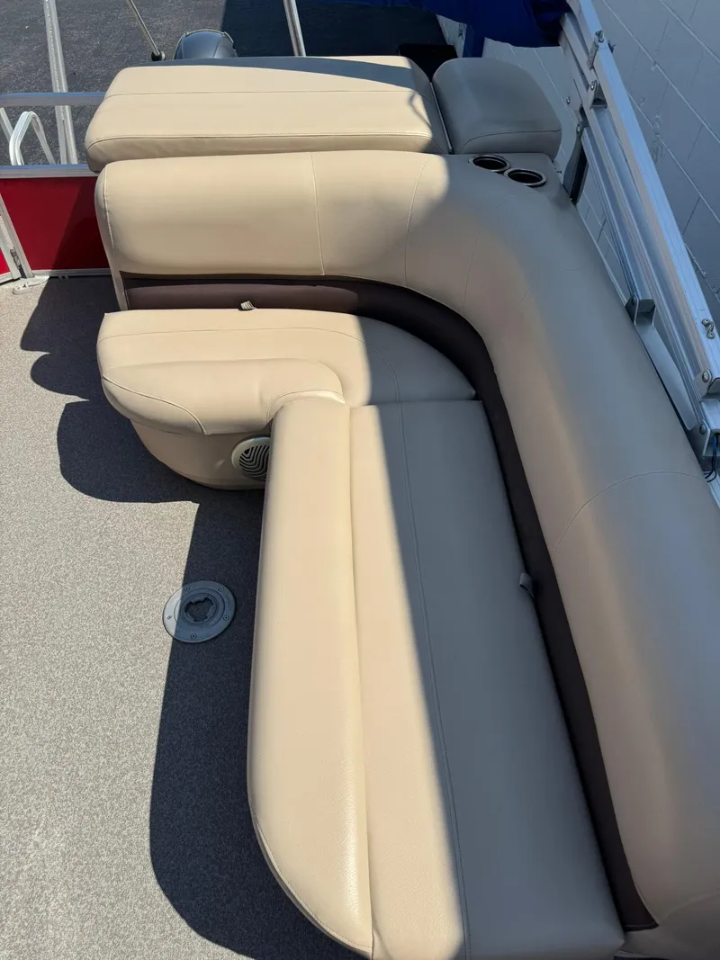 Slide: The Image of 2017 Sun Tracker Party Barge 20 DLX interior seating with beige upholstery and cup holders. - 7