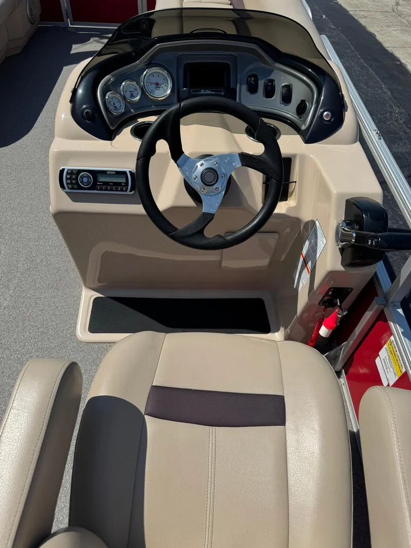 Slide: The Image of 2017 Sun Tracker Party Barge 20 DLX helm with steering wheel and gauges. - 9