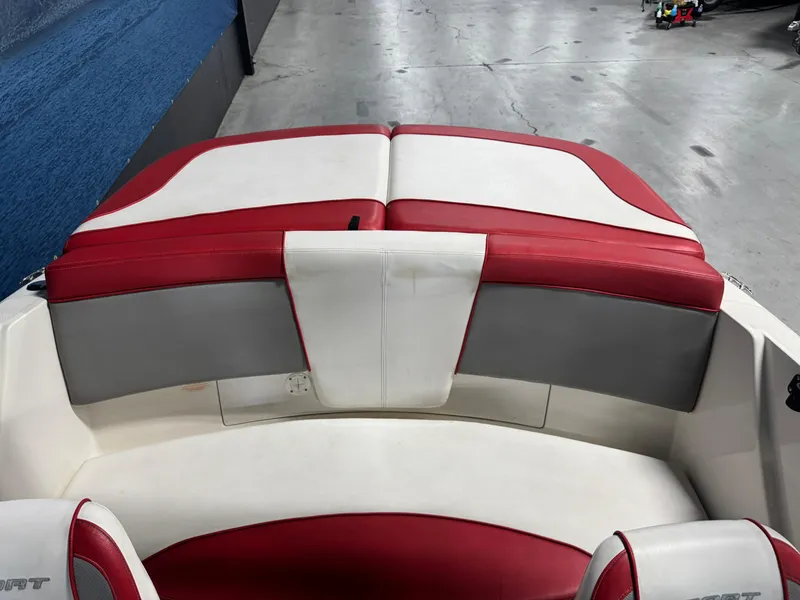 Slide: The Image of 2012 Sea Ray 185 Sport boat interior with red and white seating. - 11