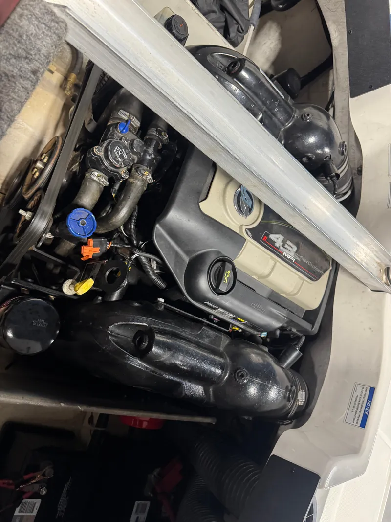 Slide: The Image of 2012 Sea Ray 185 Sport engine compartment with visible components and wiring. - 12
