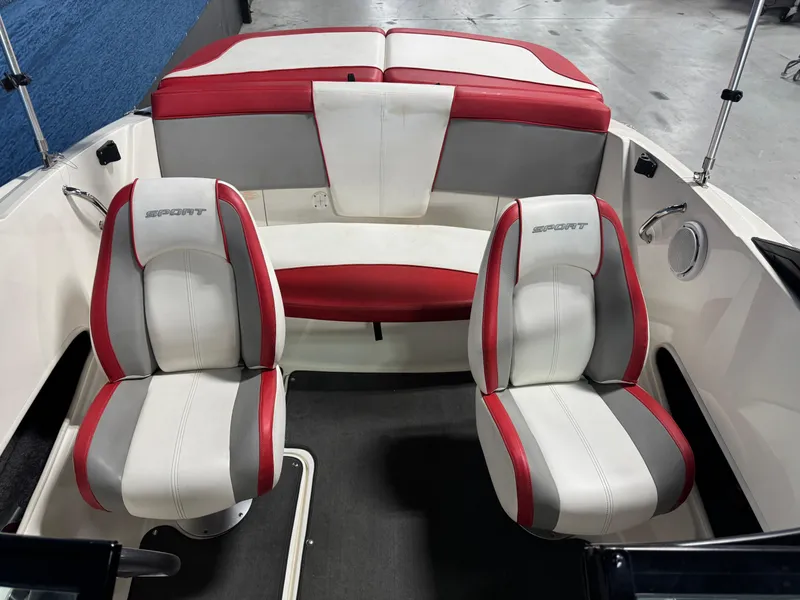 Slide: The Image of 2012 Sea Ray 185 Sport boat interior with red and white seating. - 13
