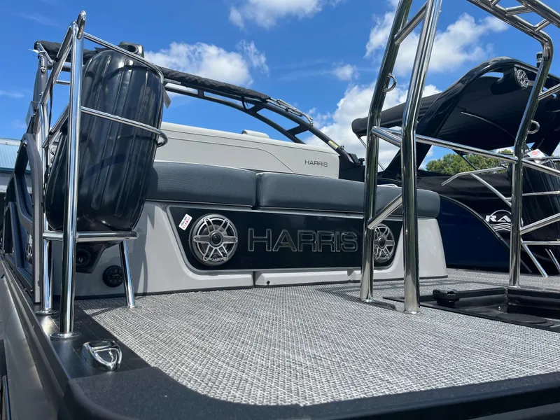 Slide: The Image of 2026 Harris Grand Mariner 230 boat deck with stainless steel railings and speakers. - 2