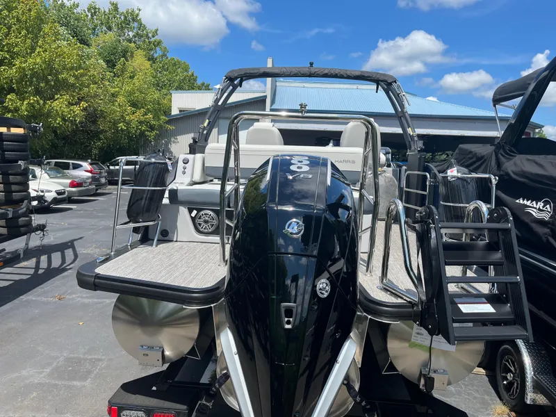 Slide: The Image of 2026 Harris Grand Mariner 230 boat with powerful engine, docked outdoors under blue sky. - 4