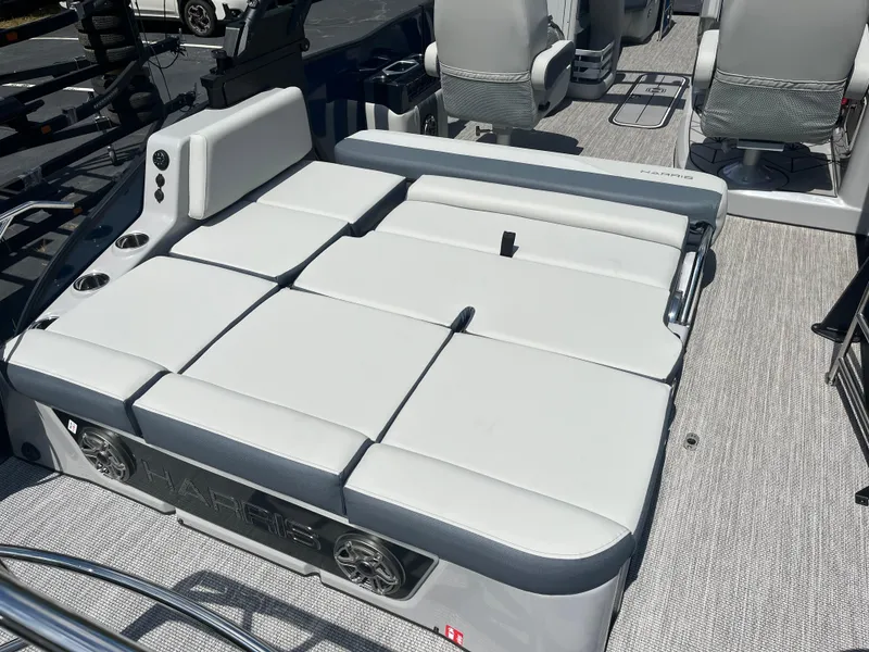 Slide: The Image of 2026 Harris Grand Mariner 230 boat interior with plush seating and cup holders. - 9